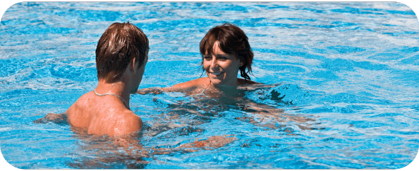 A young couple enjoying swimming together