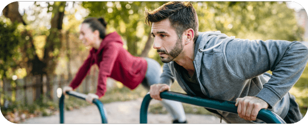 Two people performing press-ups in the local park