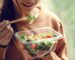 A young girl eating a healthy salad