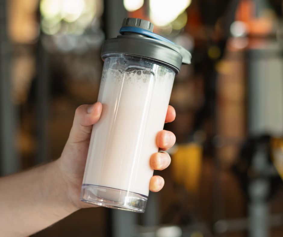 A man holding a shake with creatine
